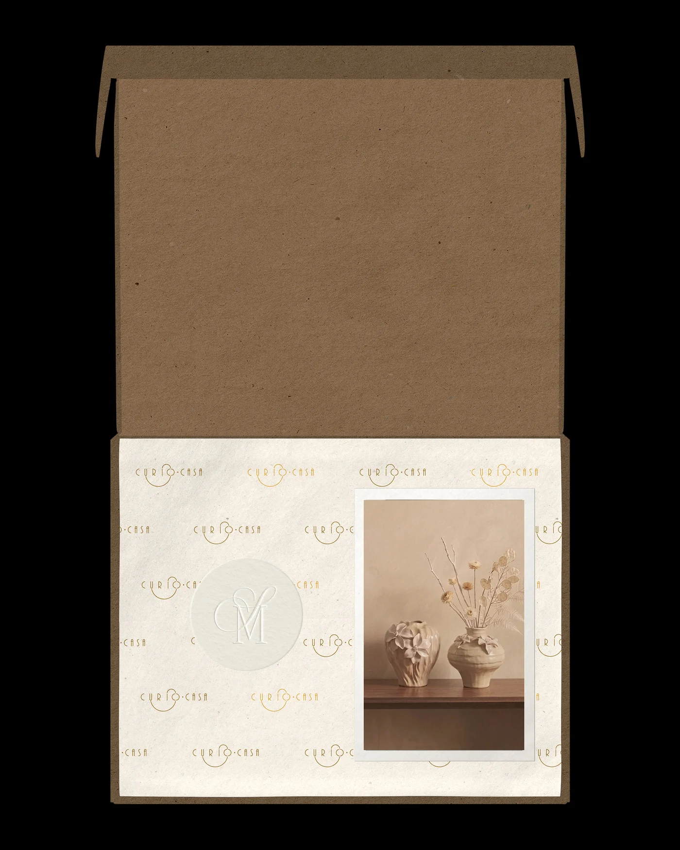 Open kraft Curiocasa shipping box with a logo-patterned insert card and product photo