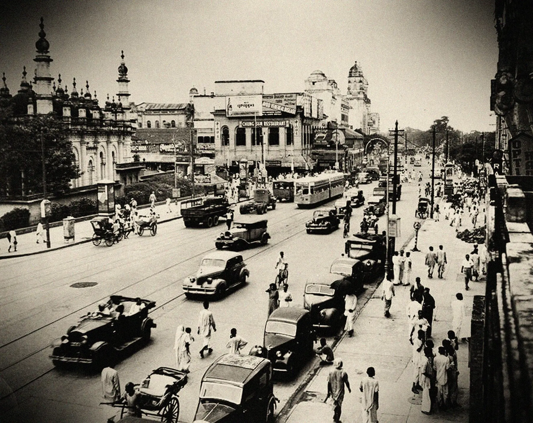Chowringhee, Calcutta, in 1945: trams, rickshaws and motor cars on a wide avenue