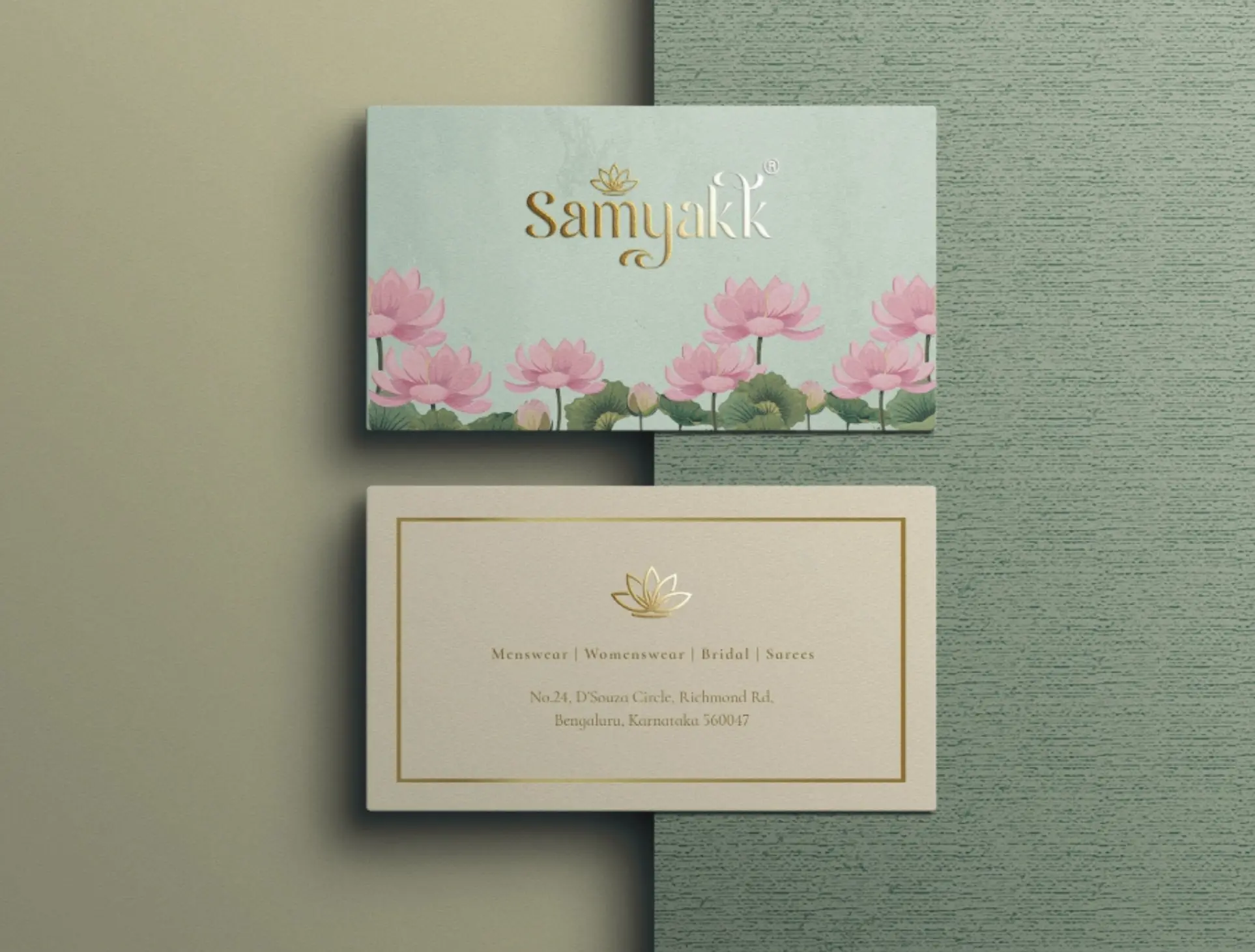 Samyakk business cards on sage: celadon front with lotus border, ivory back with gold frame