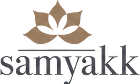 Previous Samyakk logo: a brown lotus icon above a lowercase grey serif